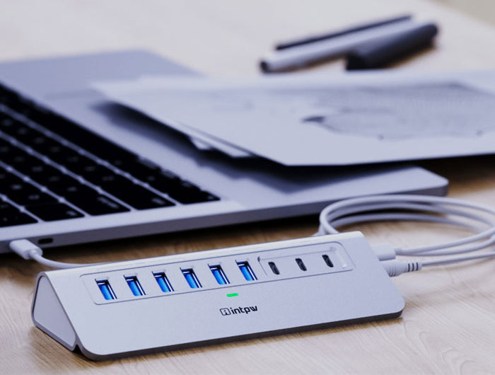 a silver intpw yh6ac powered usb hub connects the laptop with 3.3ft usb c cable.