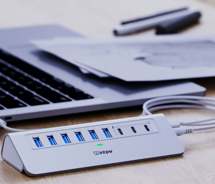 a silver intpw yh6ac powered usb hub connects the laptop with 3.3ft usb c cable.