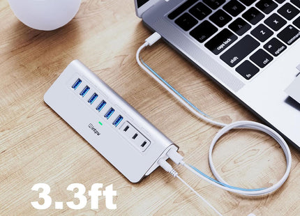 a silver intpw yh6ac powered usb hub connects the laptop with 3.3ft usb c cable.